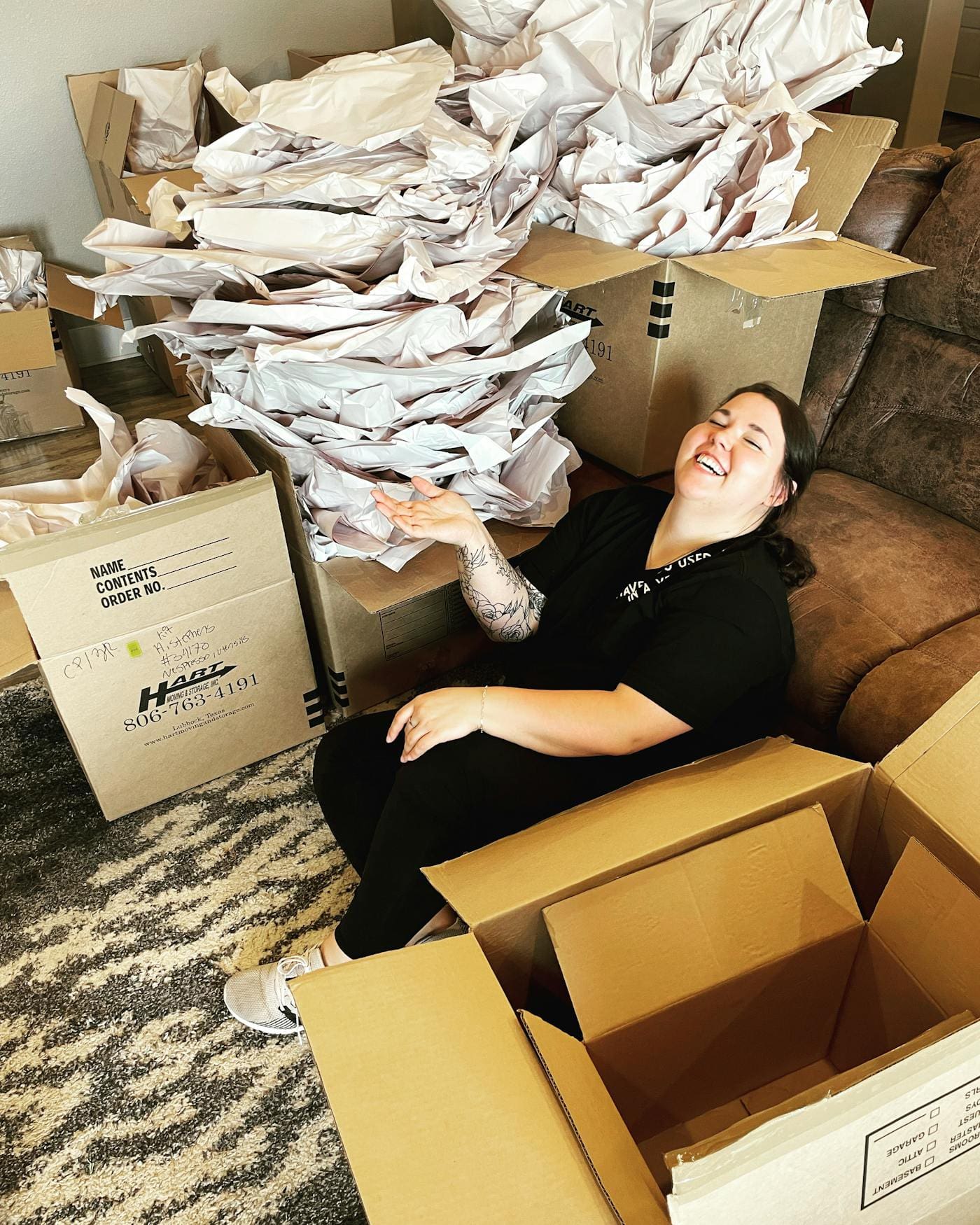 Woman laughing among boxes
