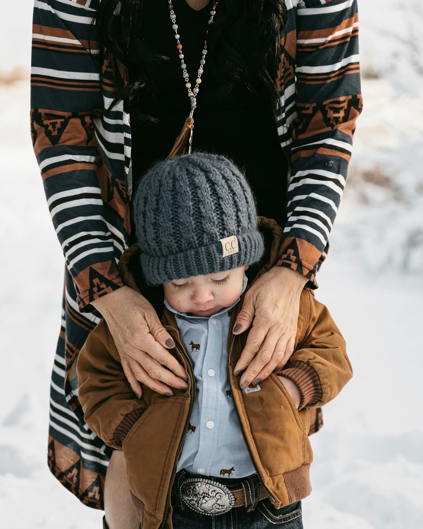 Mom holding her son in the snow, Colorado Springs